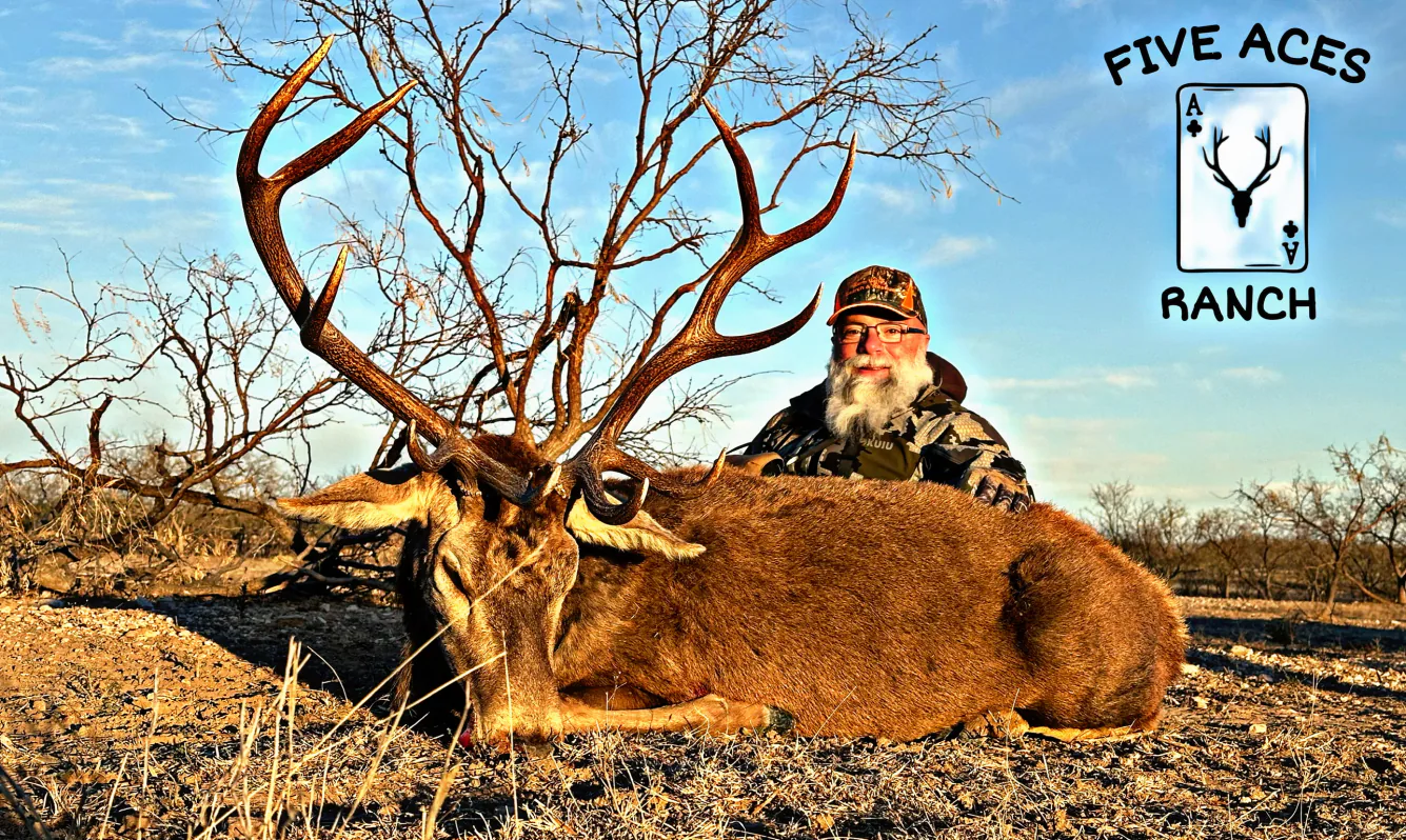 Hunter with trophy axis deer harvested at Five Aces Ranch in Millersview, TX.