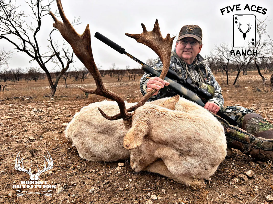 Hunter with trophy fallow deer harvested at Five Aces Ranch in Millersview, TX.