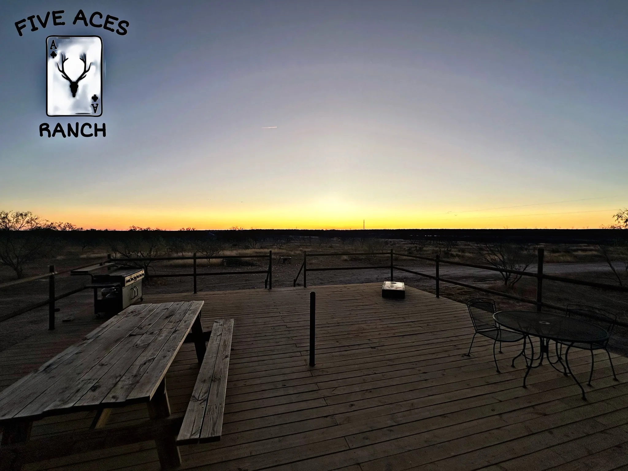 Sunset deck and fire pit at the Five Aces Ranch lodge, Concho County TX