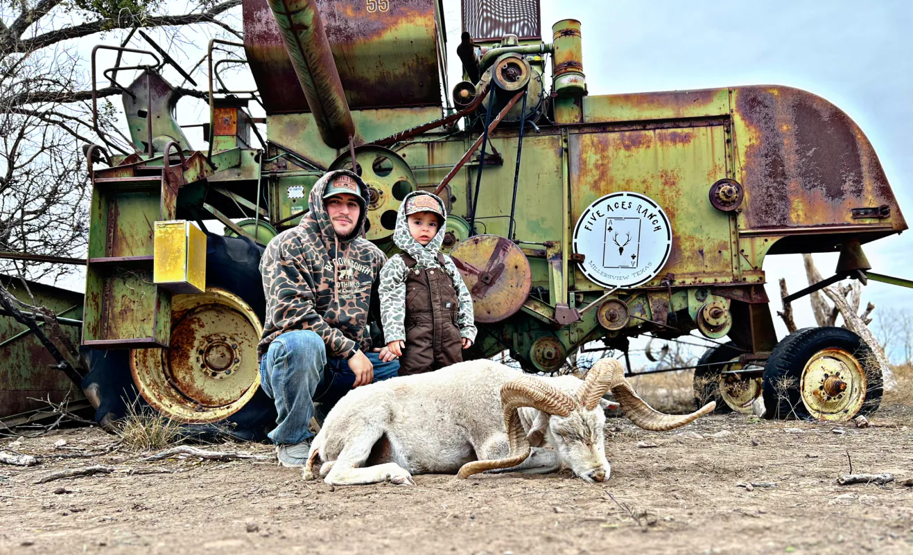 Hunter with trophy trophy ram harvested at Five Aces Ranch in Millersview, TX.