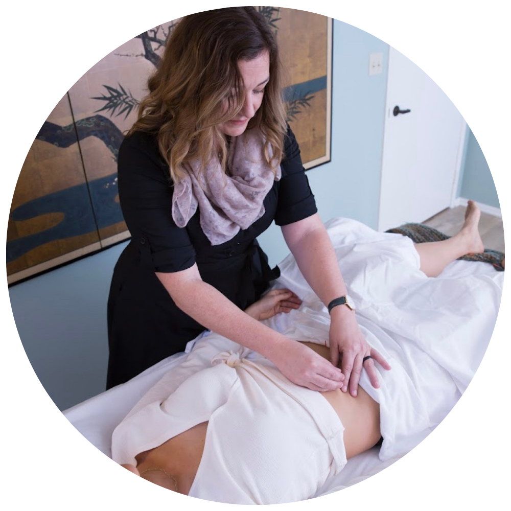 Dr. Christine Sanmiquel providing acupuncture-related clinical care.