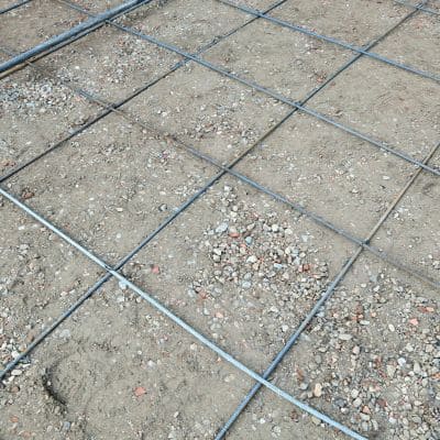 Steel grid laid on ground ready for concrete pouring.