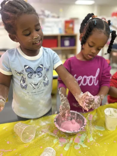 A child mixing materials during a sensory activity