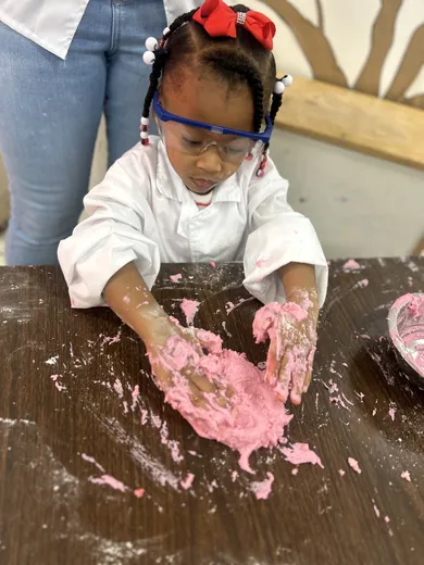 A young scientist in goggles during an experiment