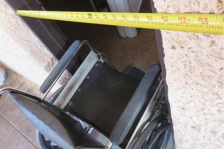 Measuring a wheelchair for a custom fit at a local mobility equipment supplier near me.