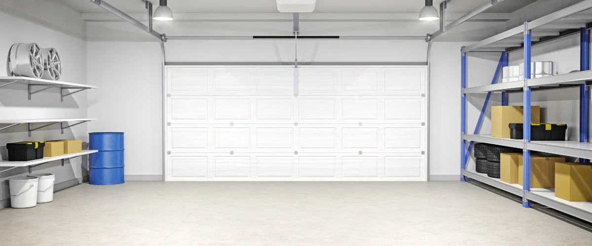 Clean organized garage interior with white door and storage shelves.