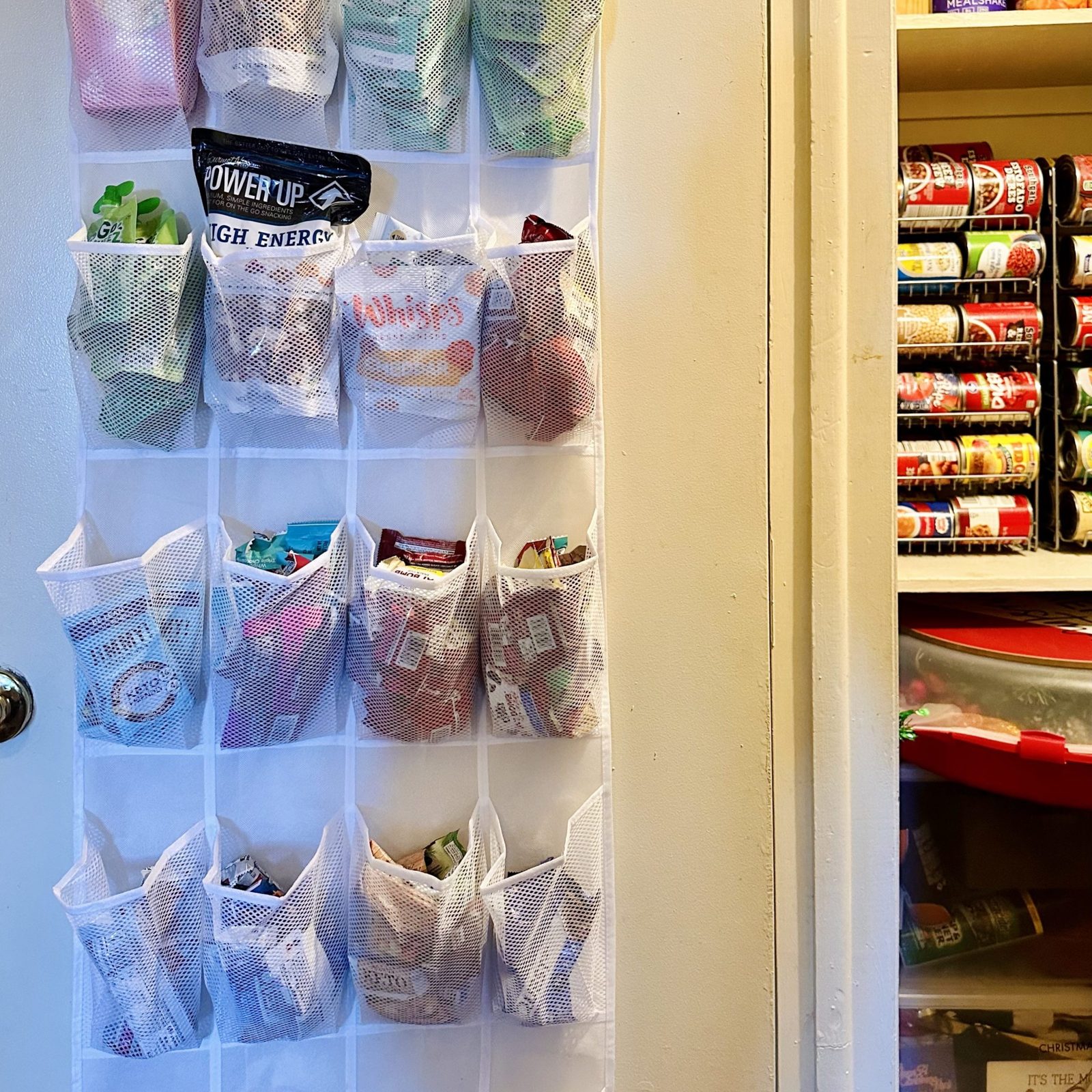 An over-the-door organizer and can racks in the finished pantry closet