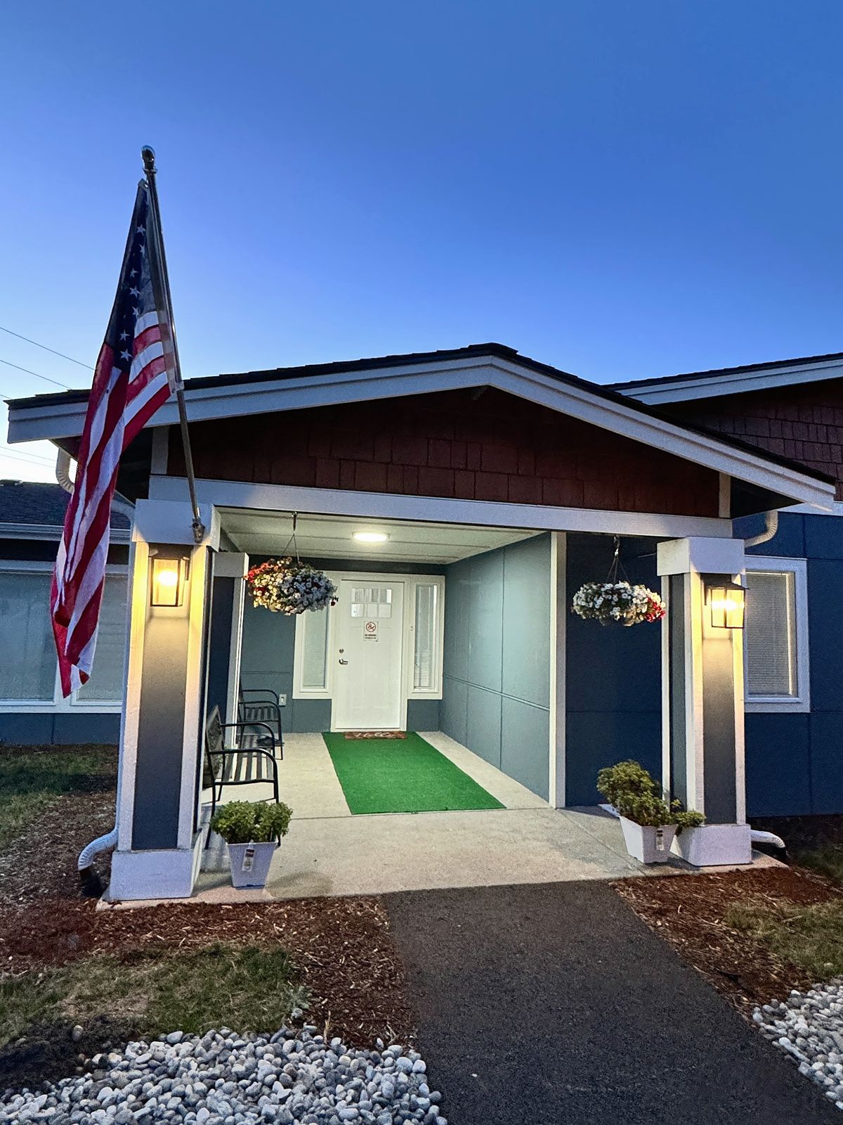 The home's front entrance lit up in the evening