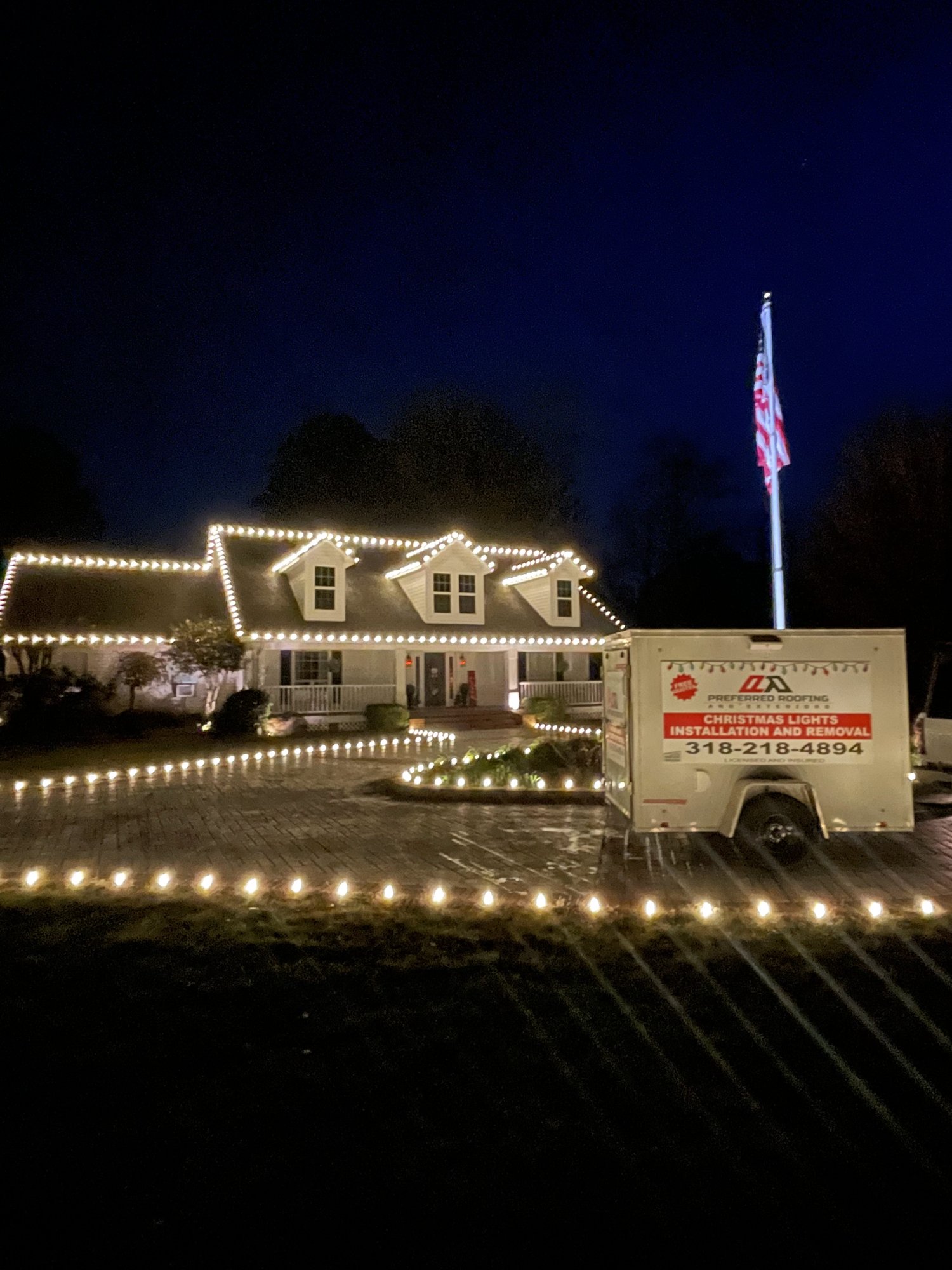 Home outlined in warm white Christmas lights