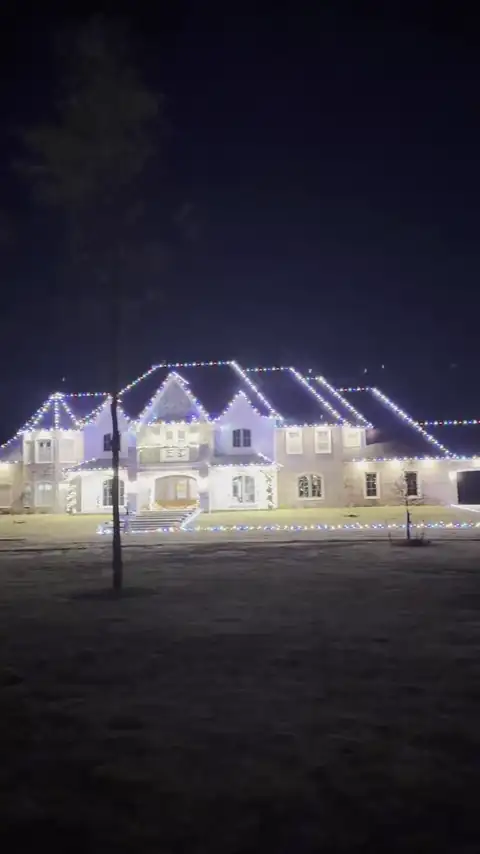 Large home outlined in multicolor Christmas lights