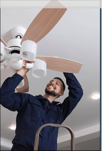 Technician installing ceiling fan
