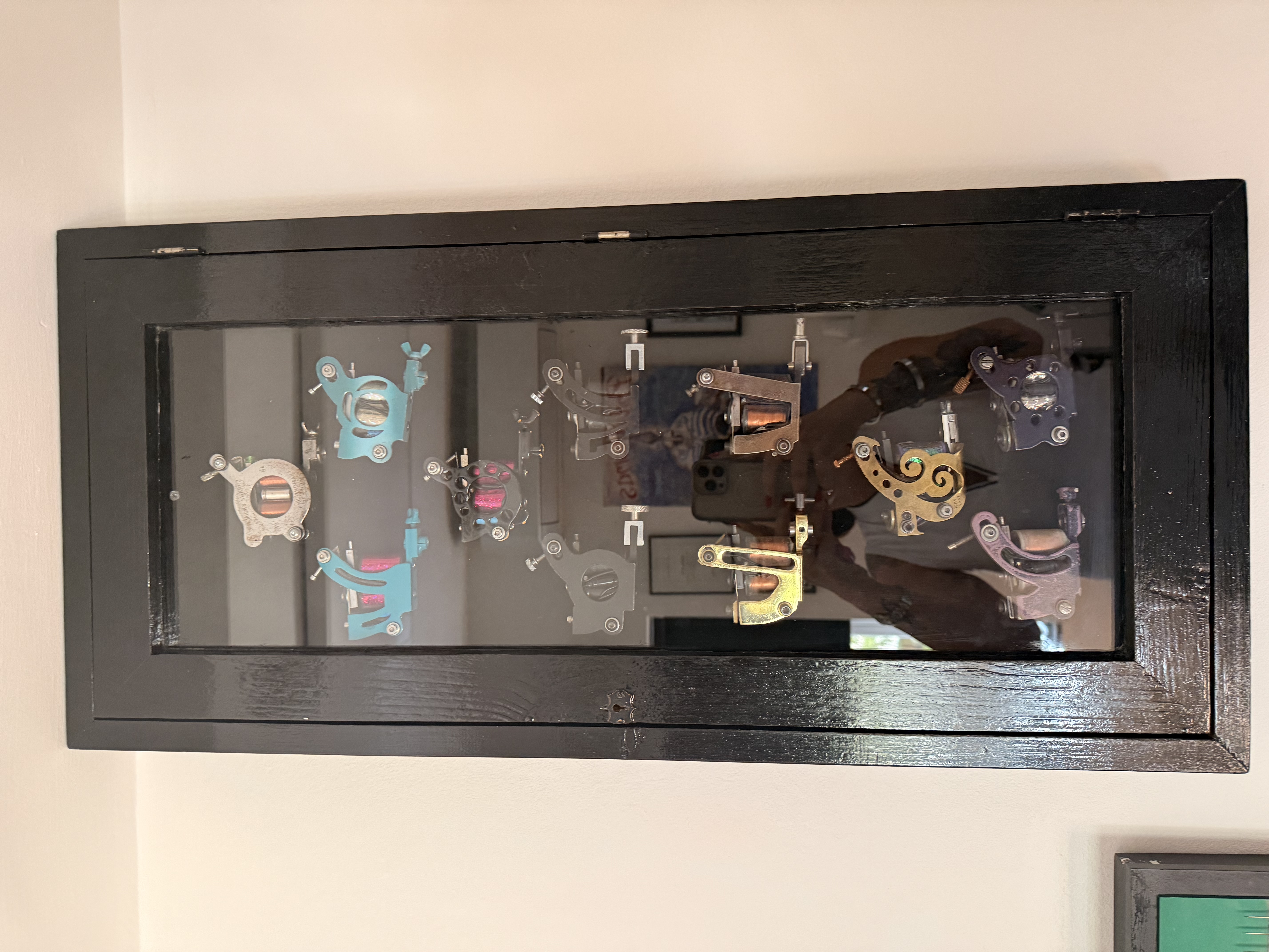 Framed display cabinet inside Tattoo Phil's