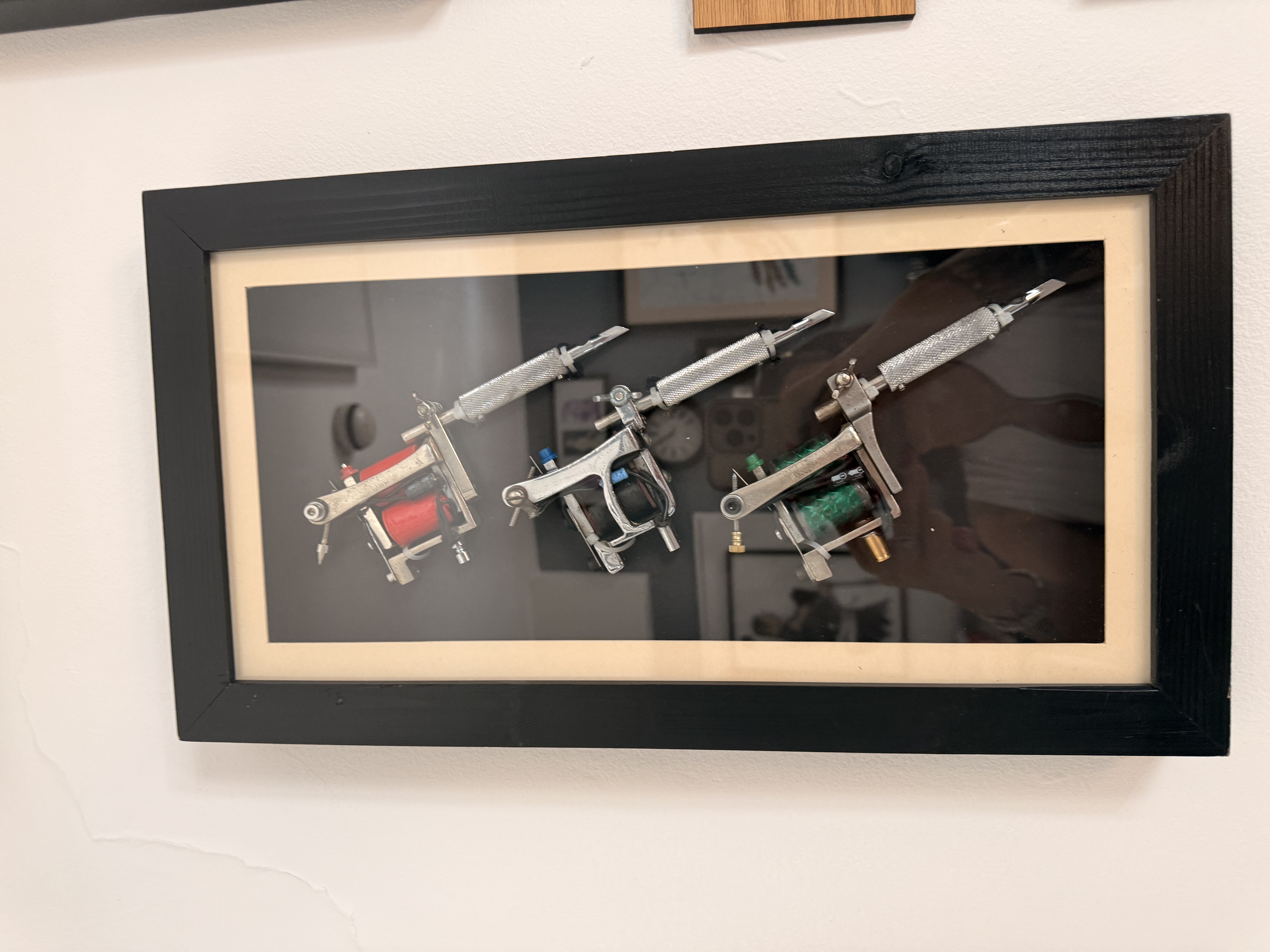 Framed tattoo artwork displayed in the studio