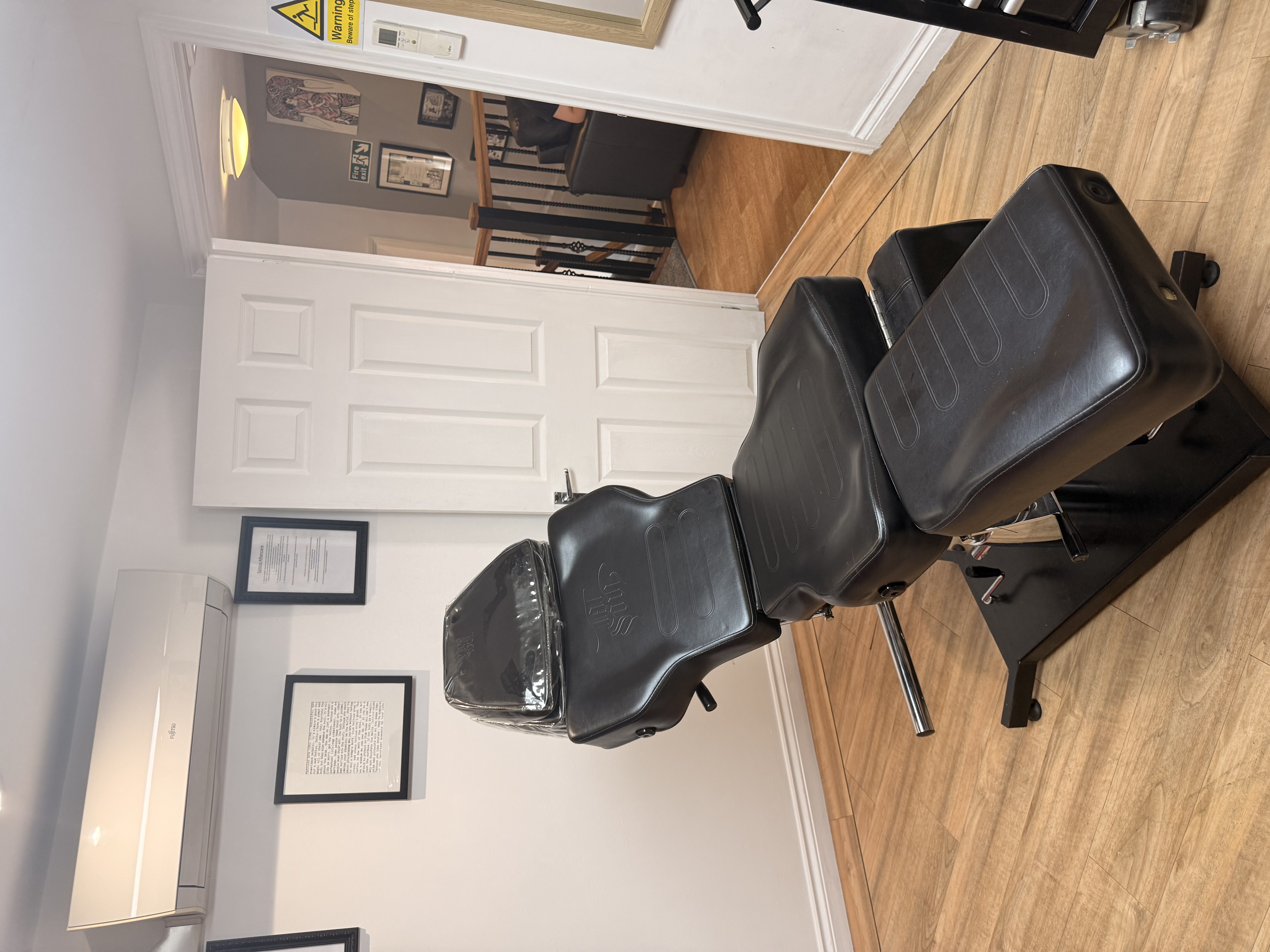 Black treatment chair in a private studio room