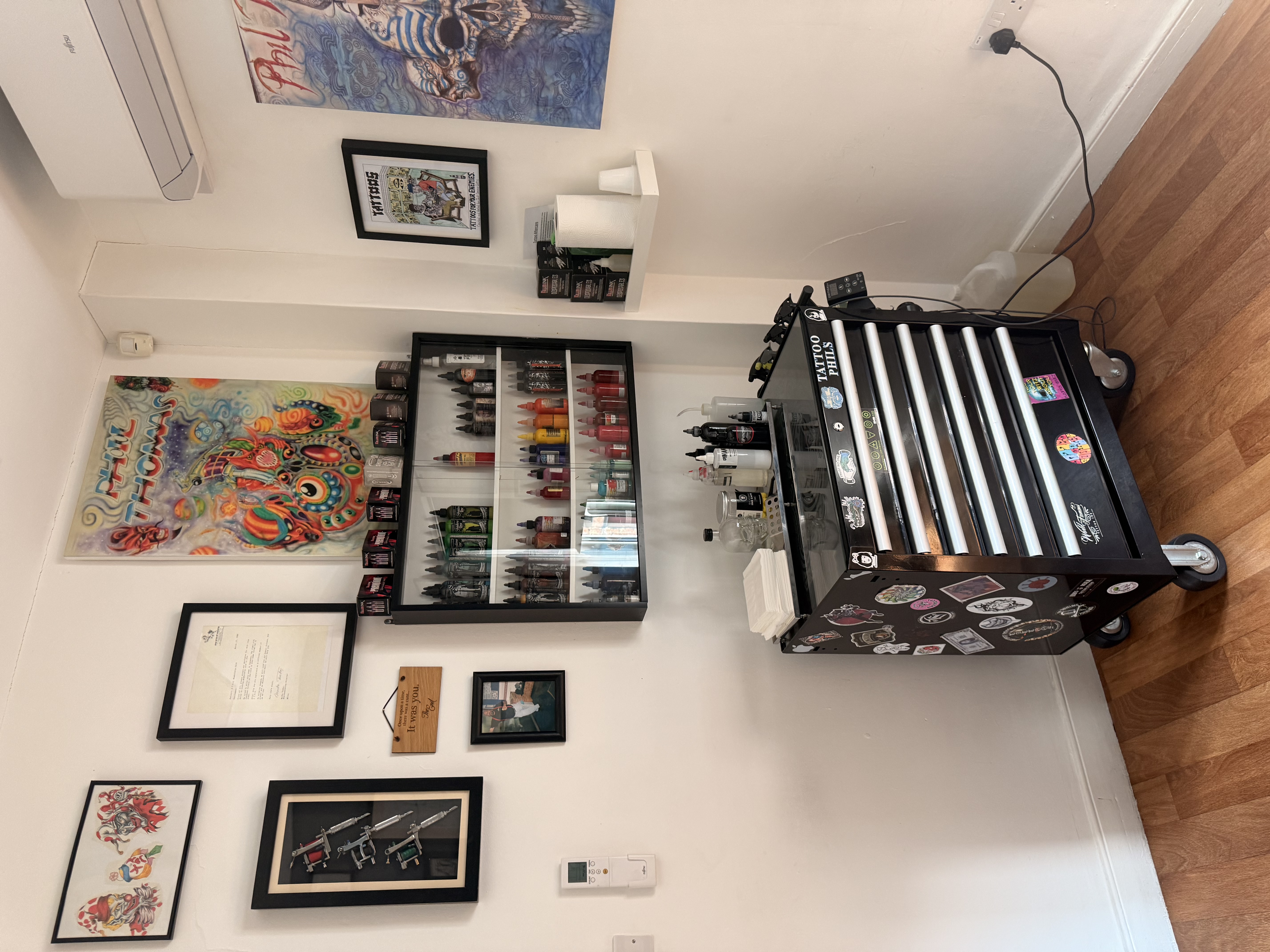 Tattoo workstation surrounded by original artwork
