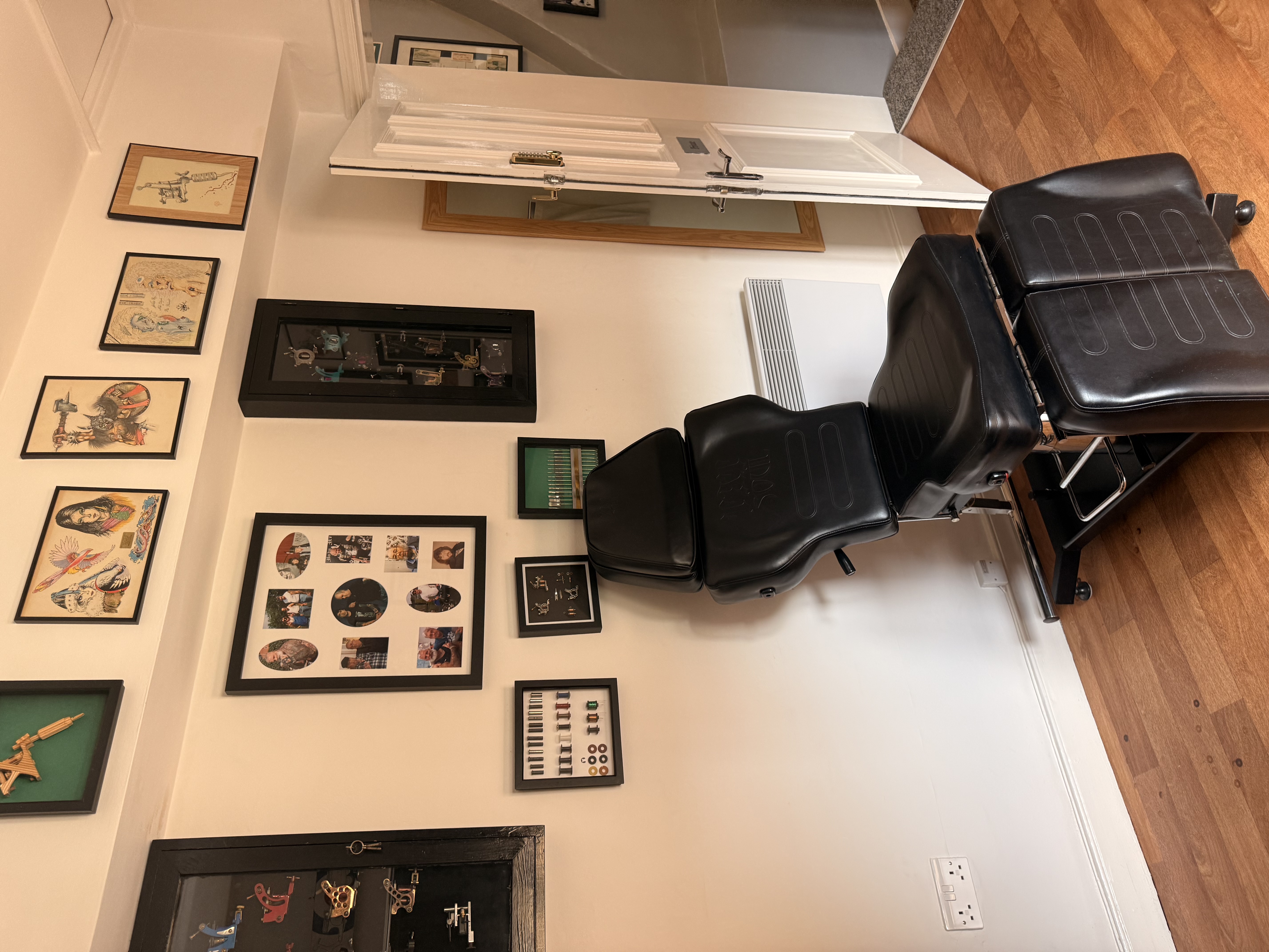Tattoo treatment room with framed flash artwork