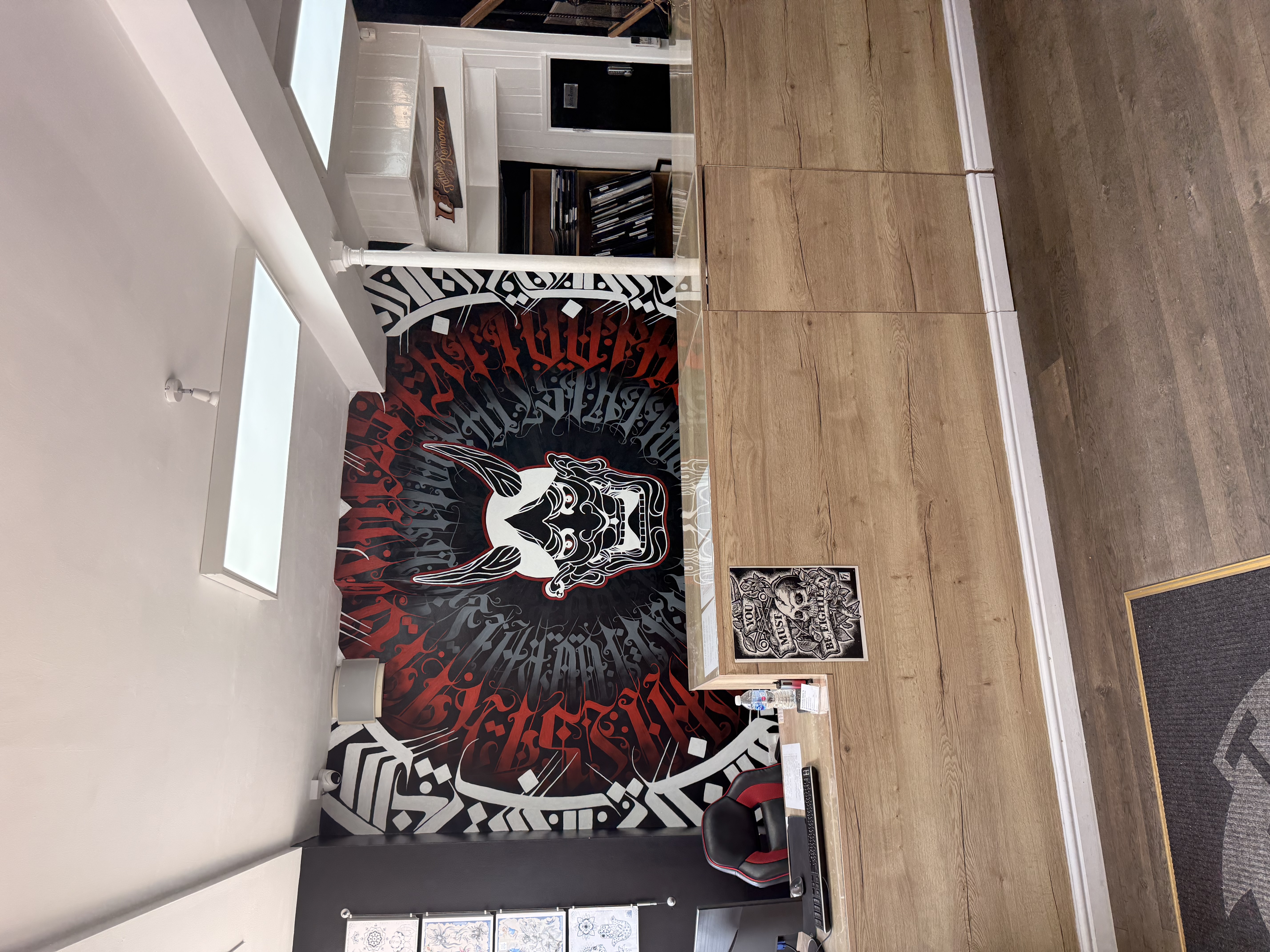 Tattoo Phil's reception desk and signature wall mural