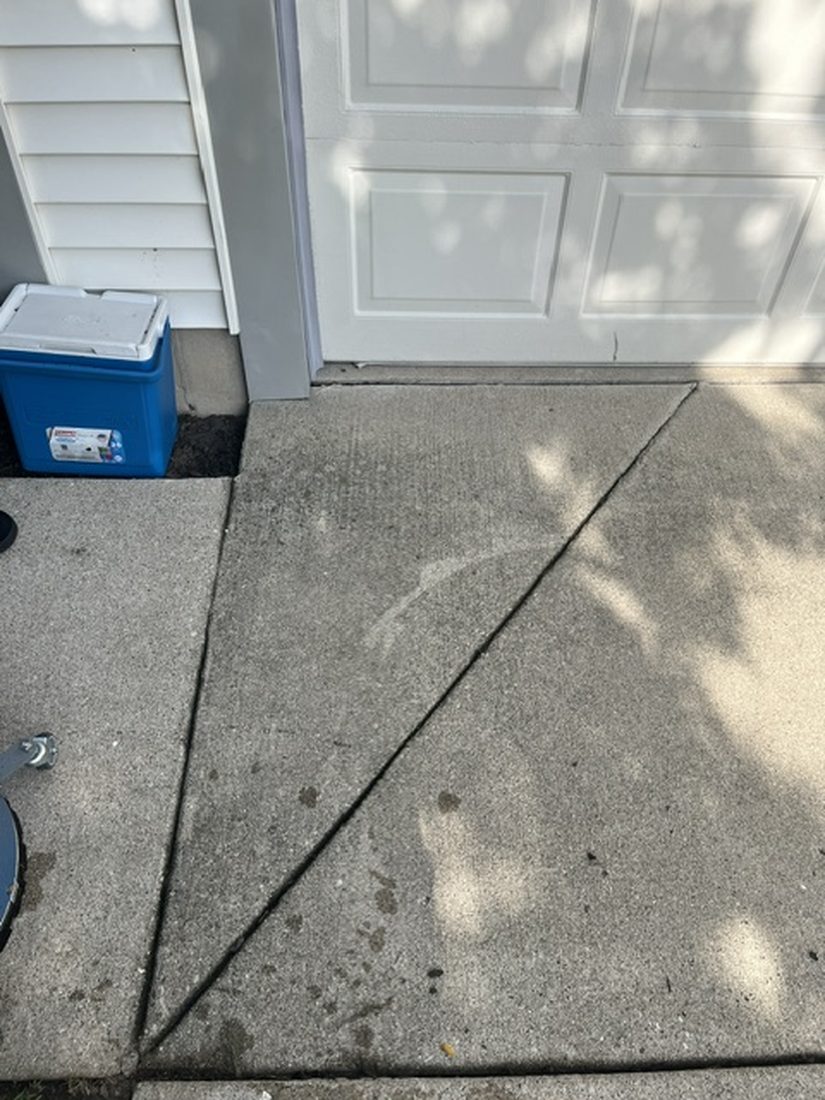 Stained concrete apron before pressure washing