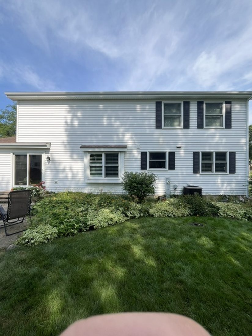 The same house after a full exterior wash, clean white siding