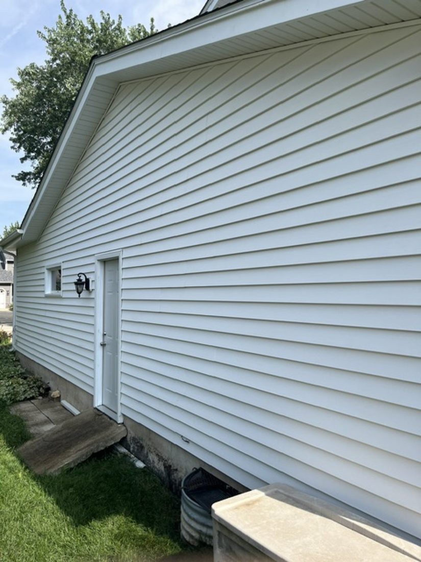 The same vinyl siding after washing, clean and white