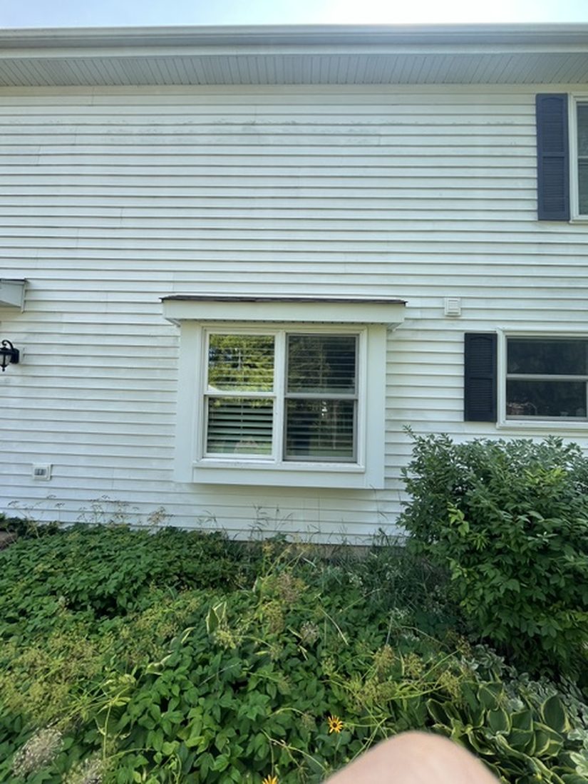 House siding before washing, streaked and dull
