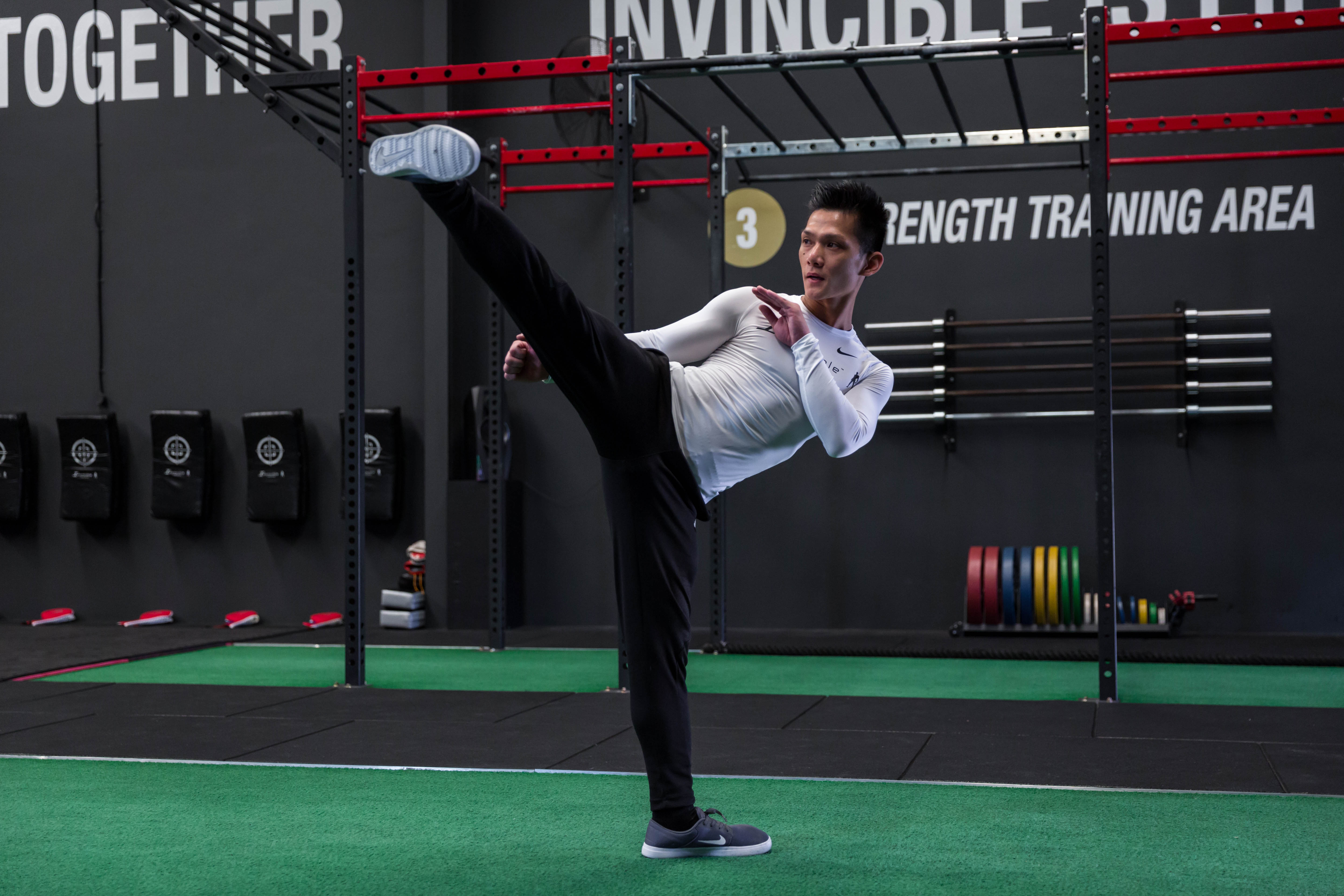 Invincible athlete throwing a kick in training