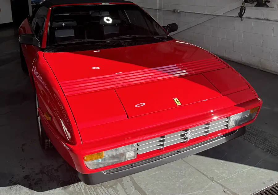 Classic red Ferrari in morning light at the AutoCore shop