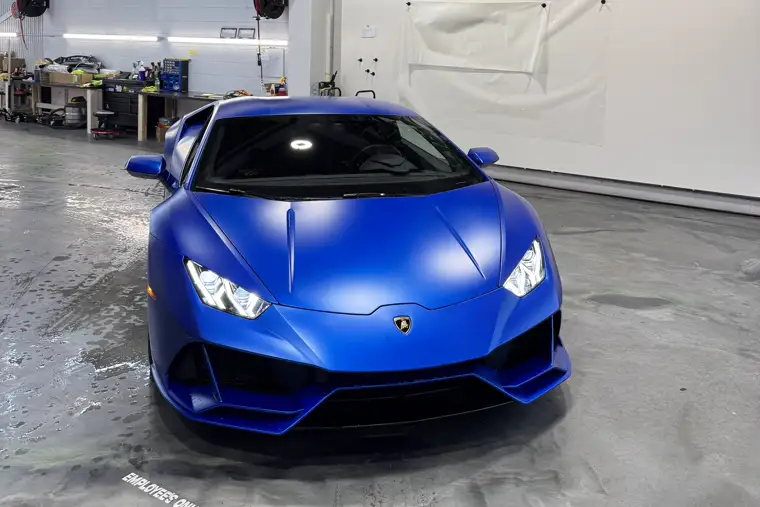 Satin blue Lamborghini Huracán full side profile in the AutoCore shop
