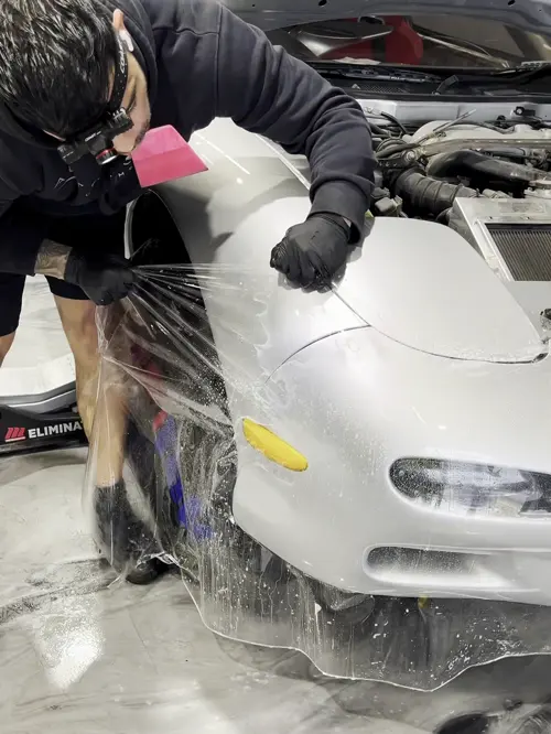 Clear film stretched over a fender mid-install