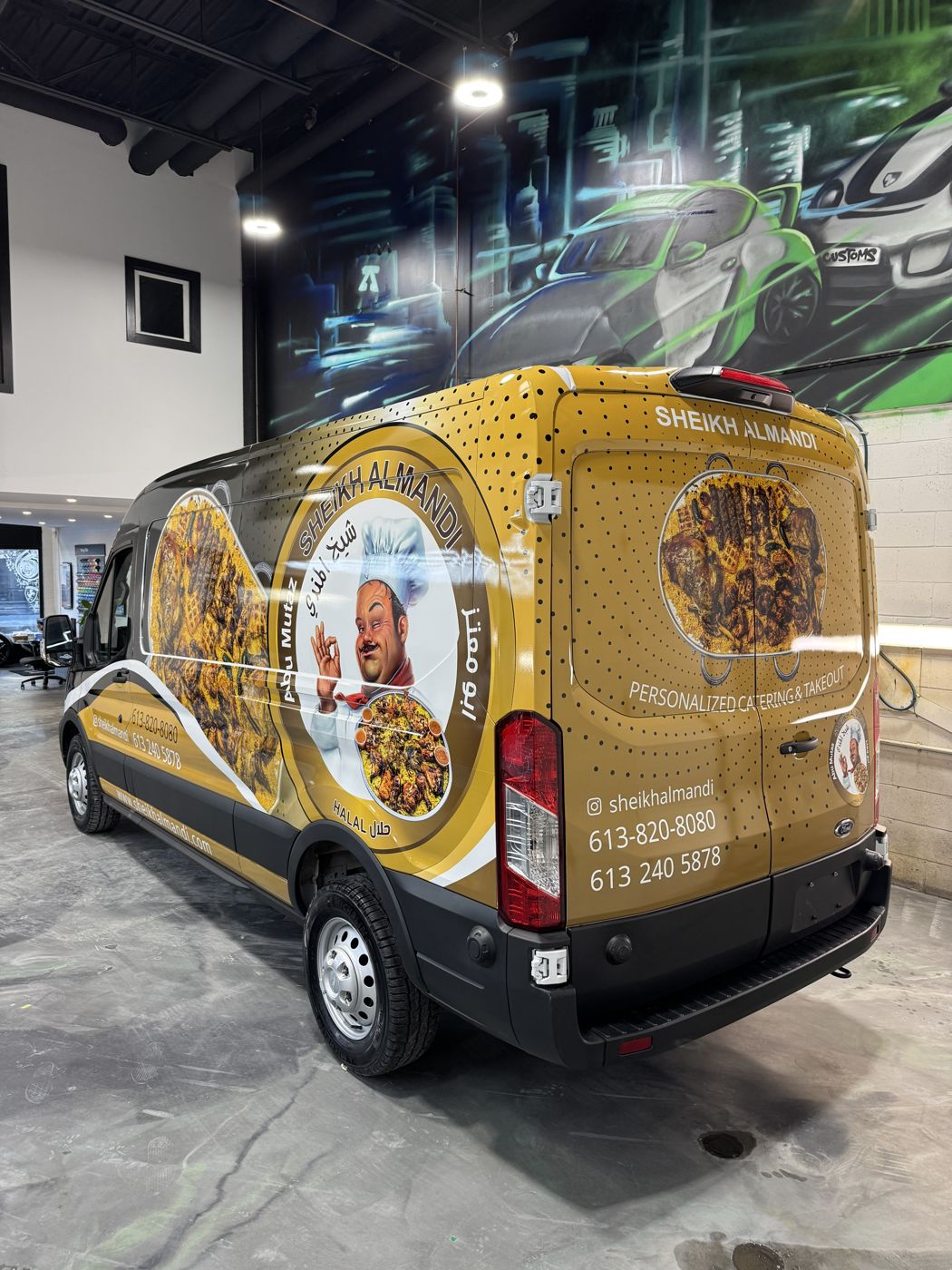 Full custom-printed wrap on a Ford Transit, rear three-quarter view