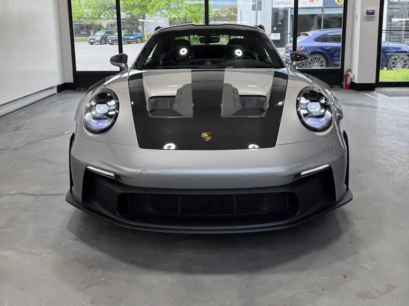 Silver Porsche GT3 RS head-on in the AutoCore showroom