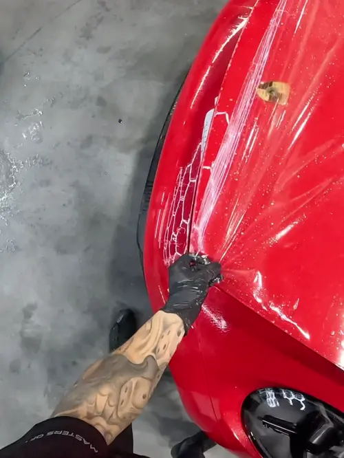 Clear film wet-laid across a hood