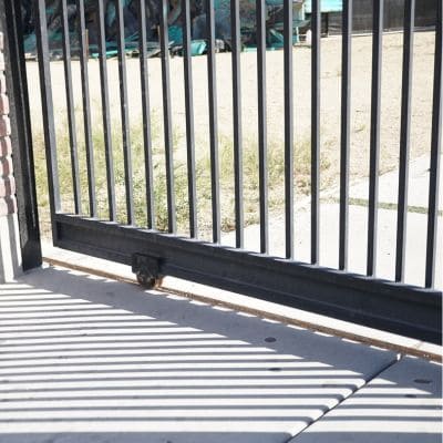 Sturdy black metal sliding gate with vertical bars