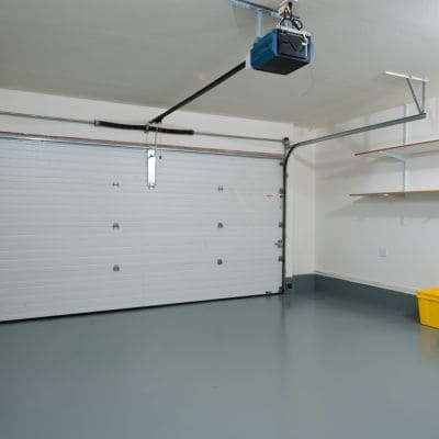 Automated white garage door system installed in a clean