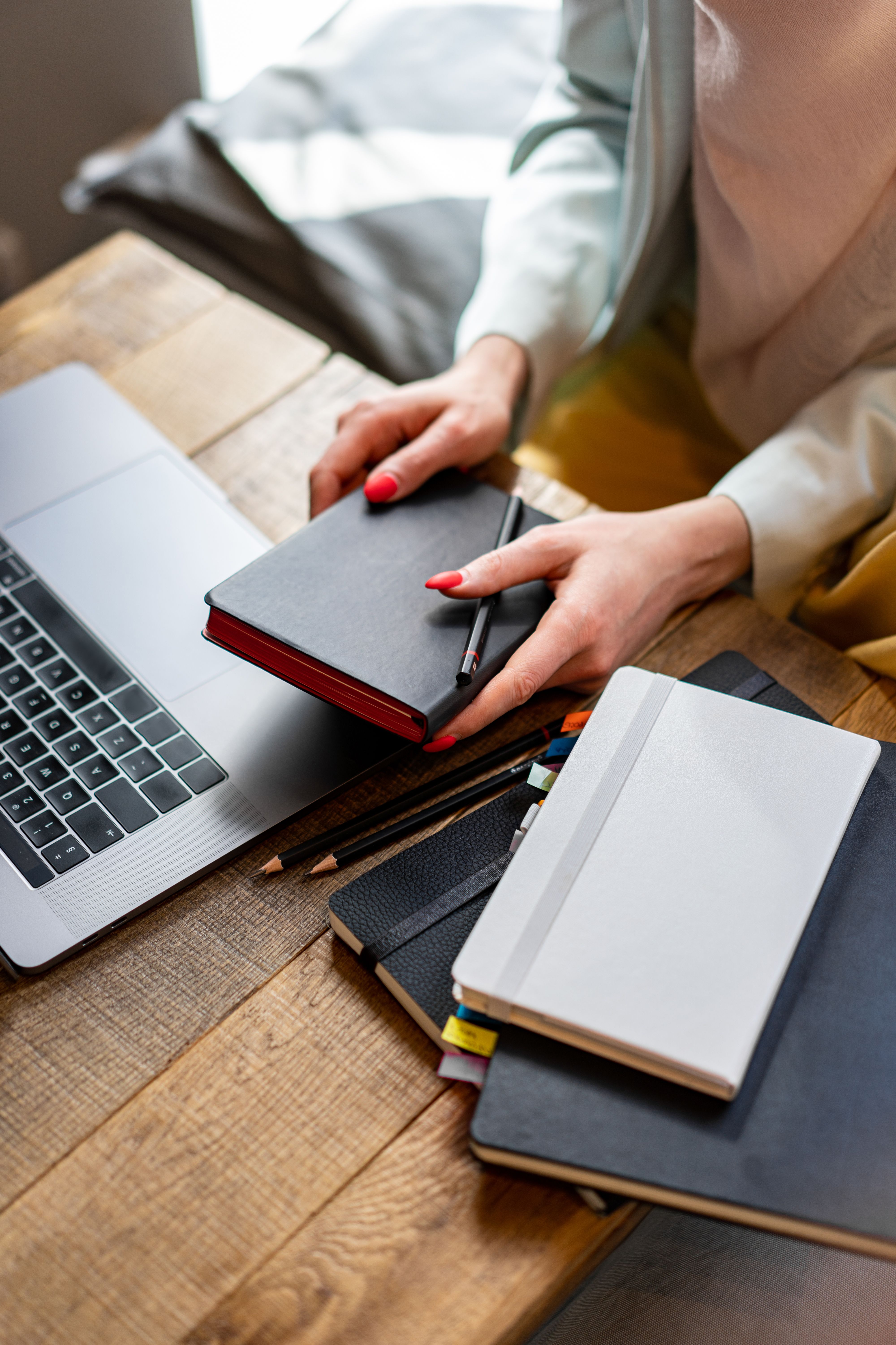 Woman holding notebook at table