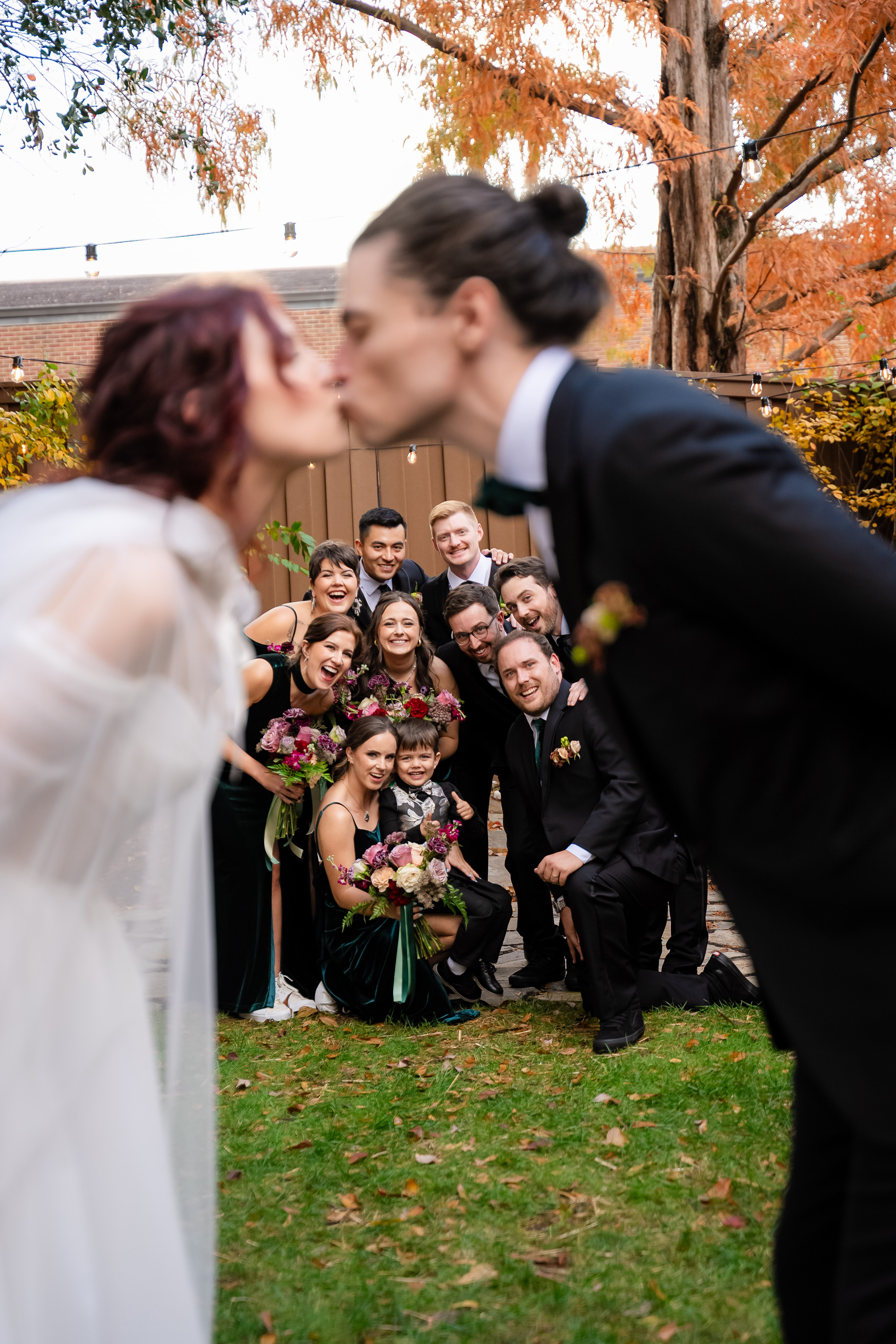 Couple kissing while their friends cheer around them