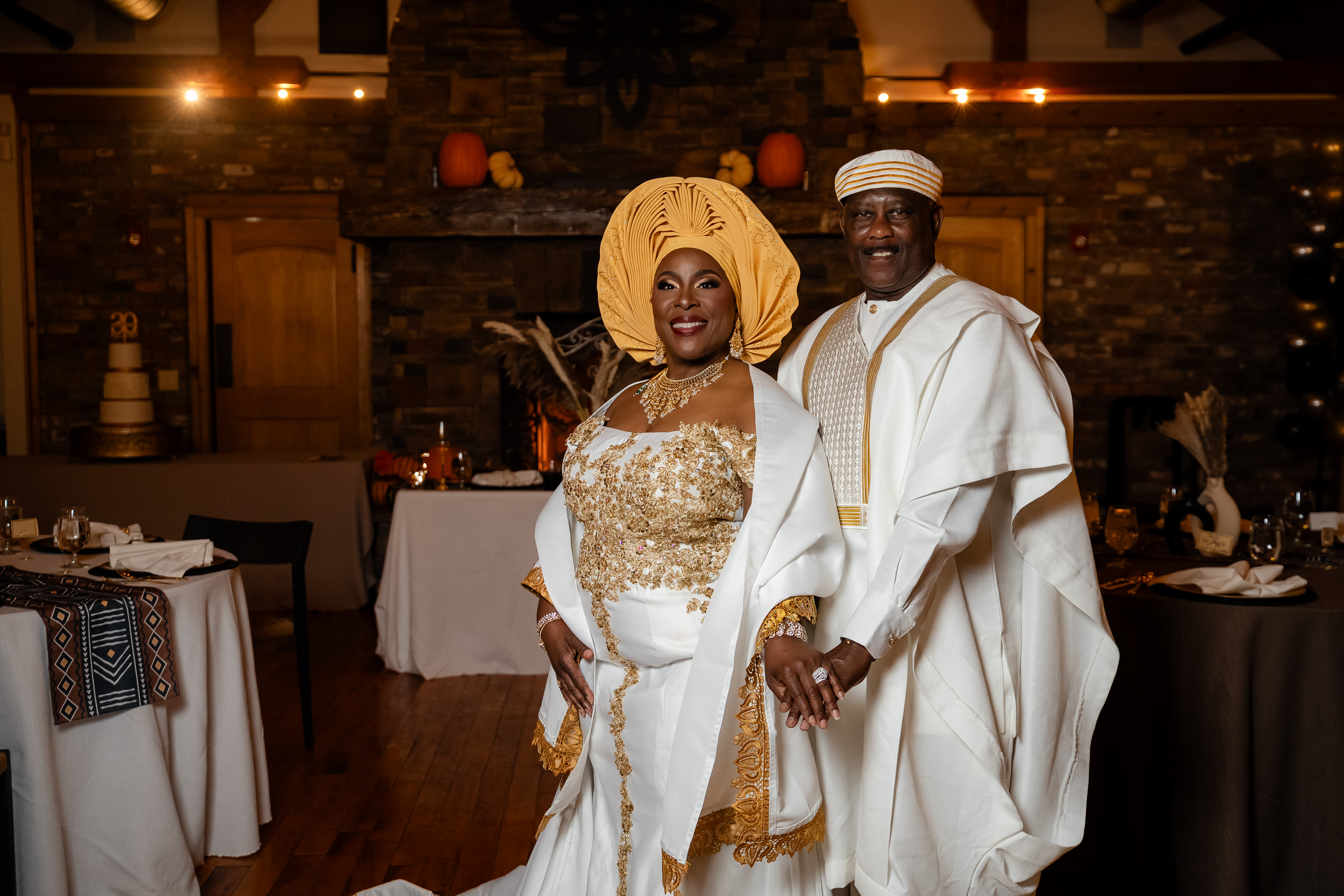 Couple in gold traditional dress at their reception