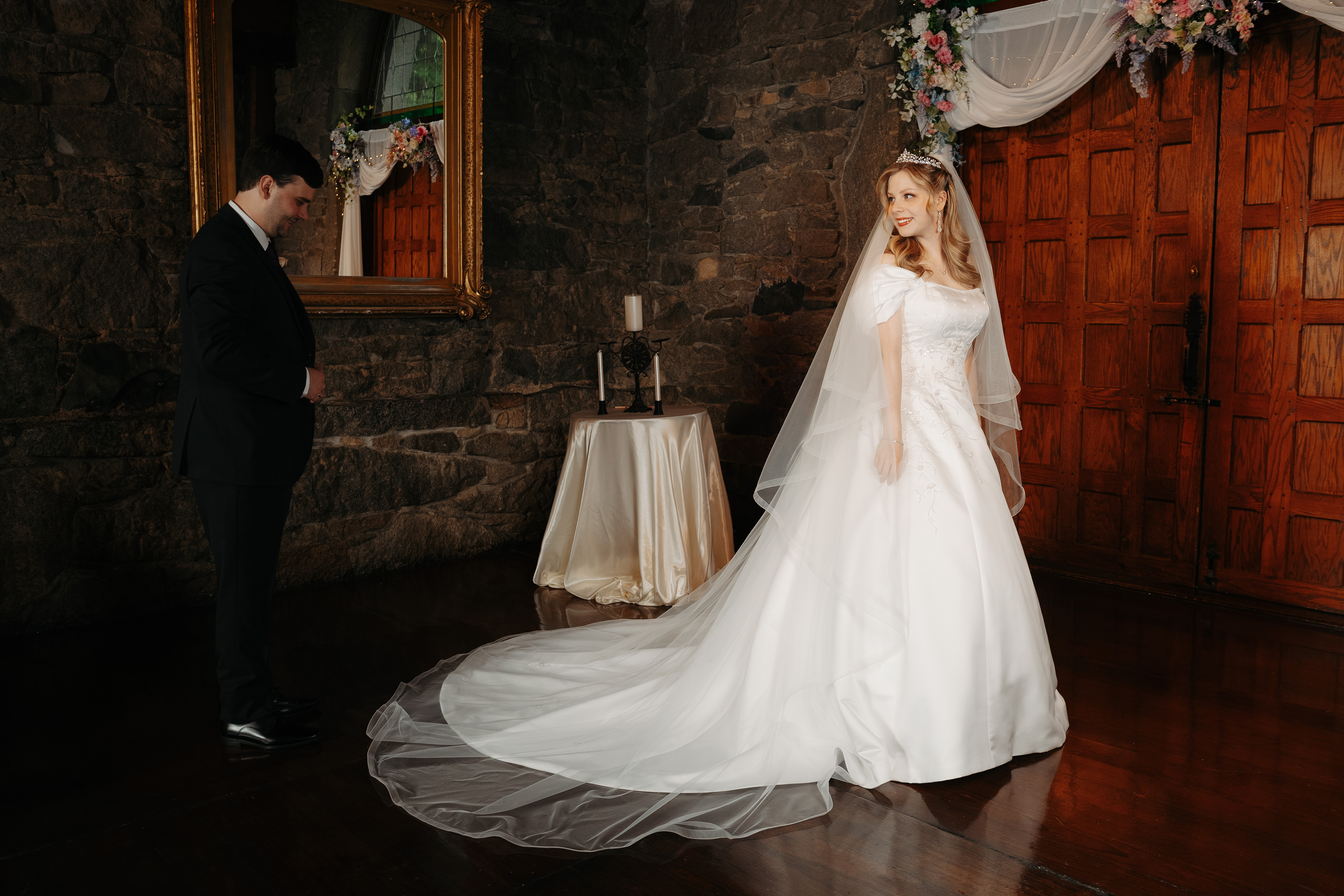 Bride in a stone room before her first look
