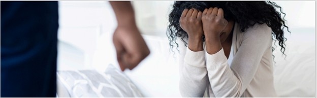 woman crying behind a mans fist