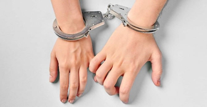 Two different hands cuffed together