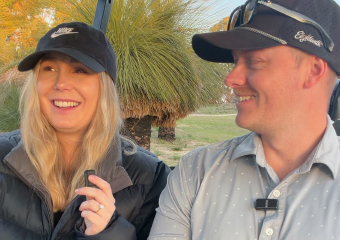 Two golfers sharing a moment in a golf cart