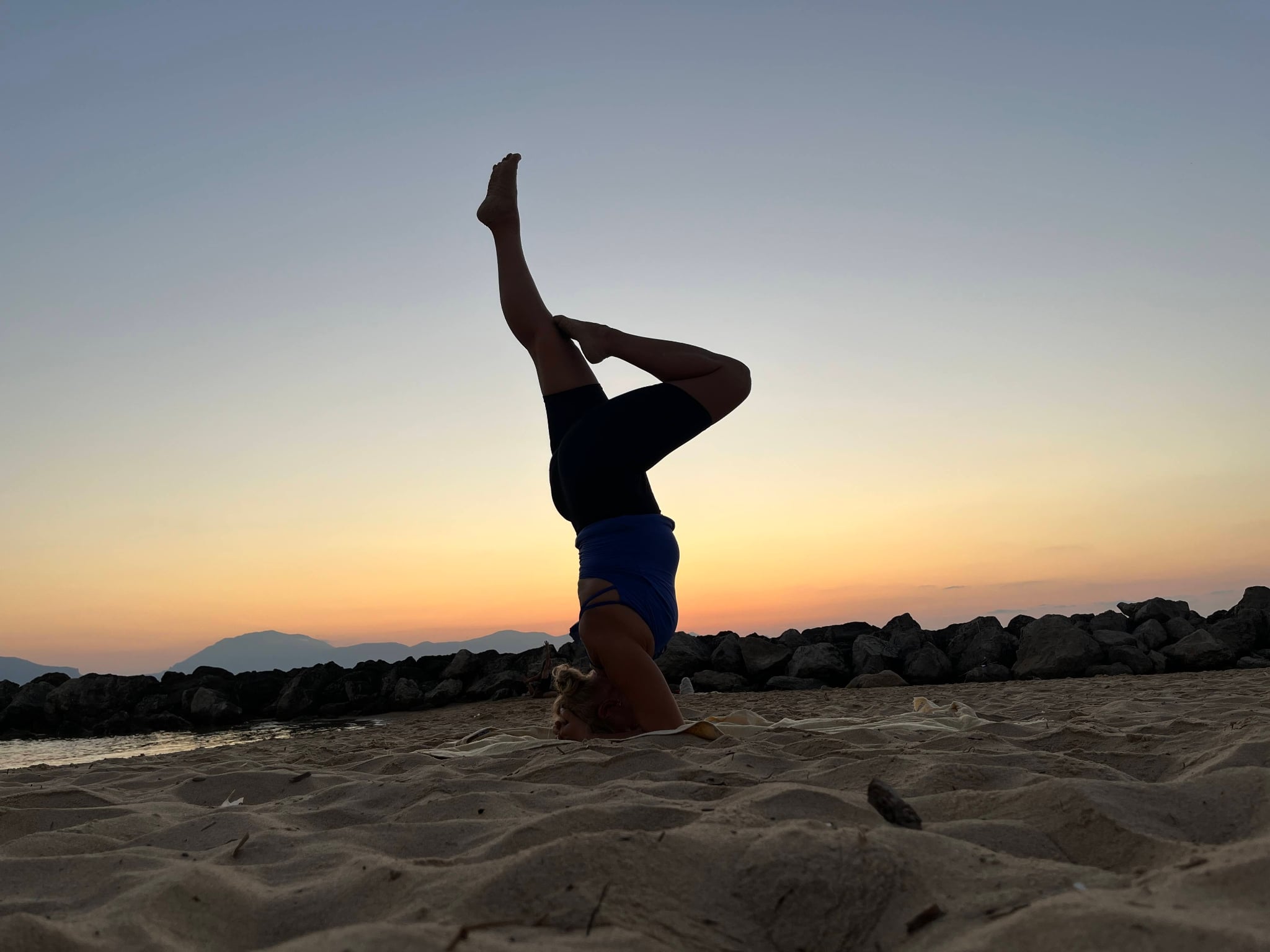Yoga practice on a Mediterranean stone terrace overlooking the sea