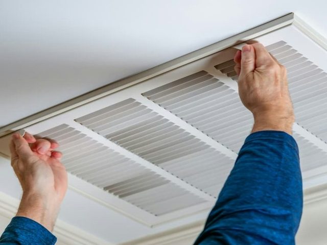 Opening a ceiling return-air vent to service the filter