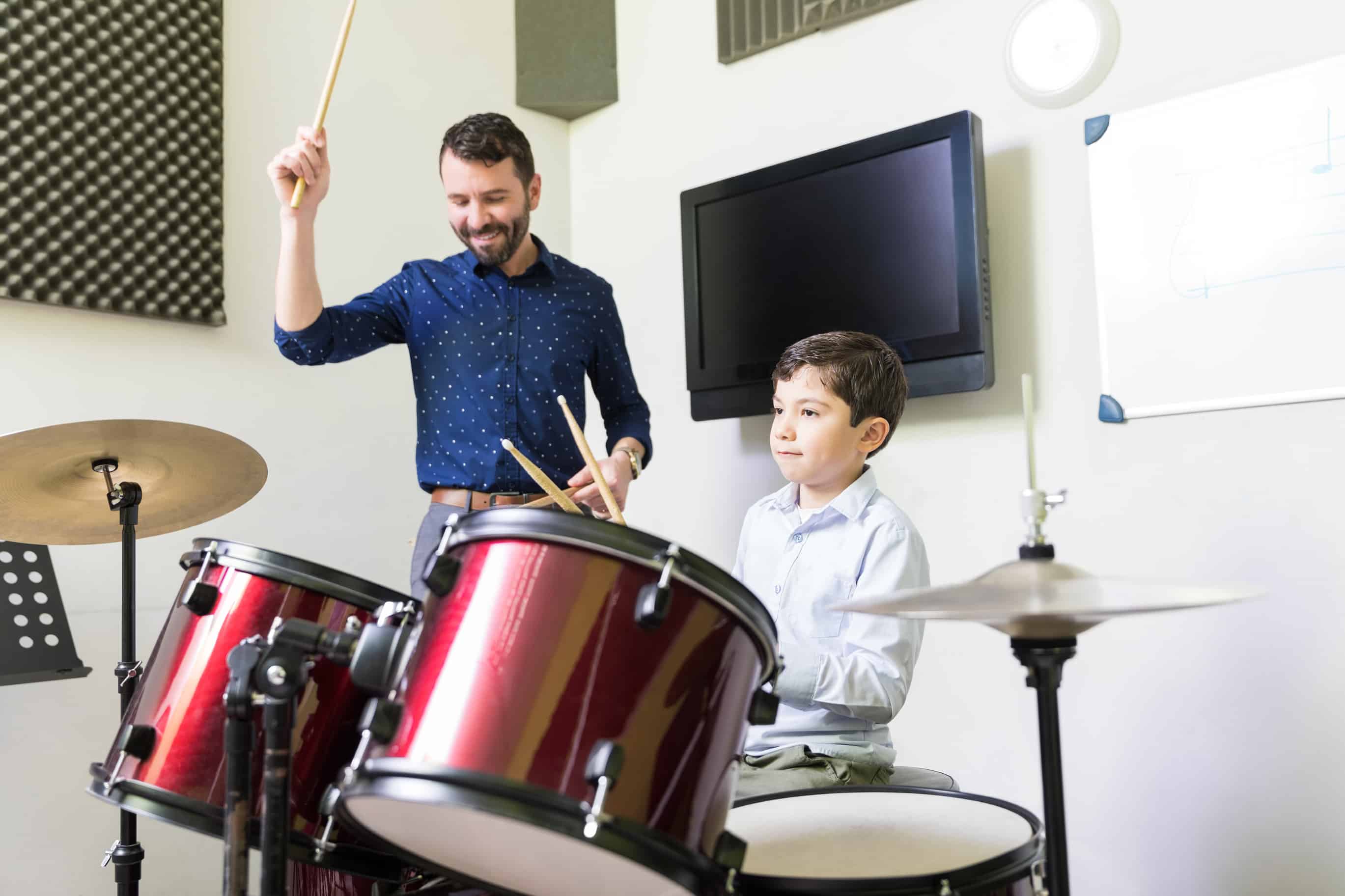 boy and a man playing drums