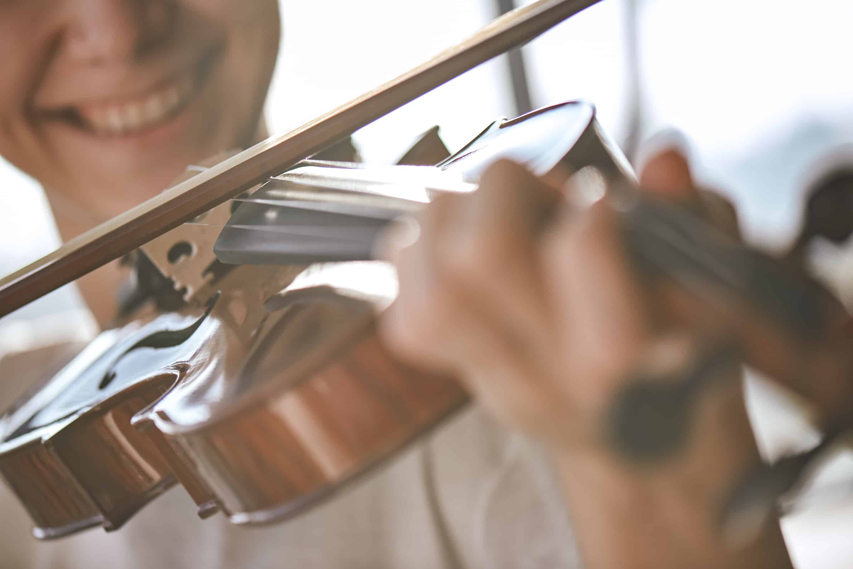 smiling while playing violin
