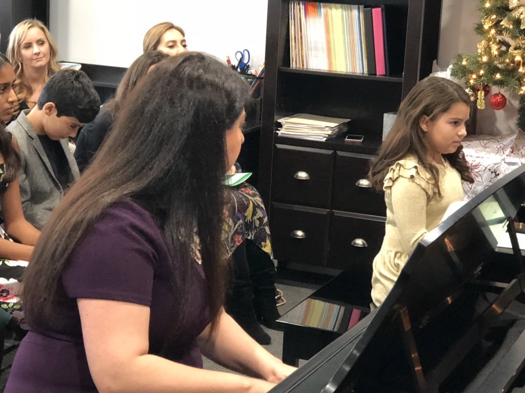 teacher and student playing piano