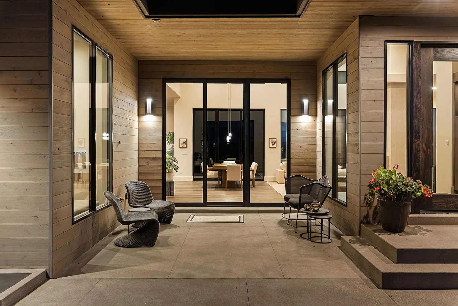 Multi-slide door system opening onto a patio at dusk