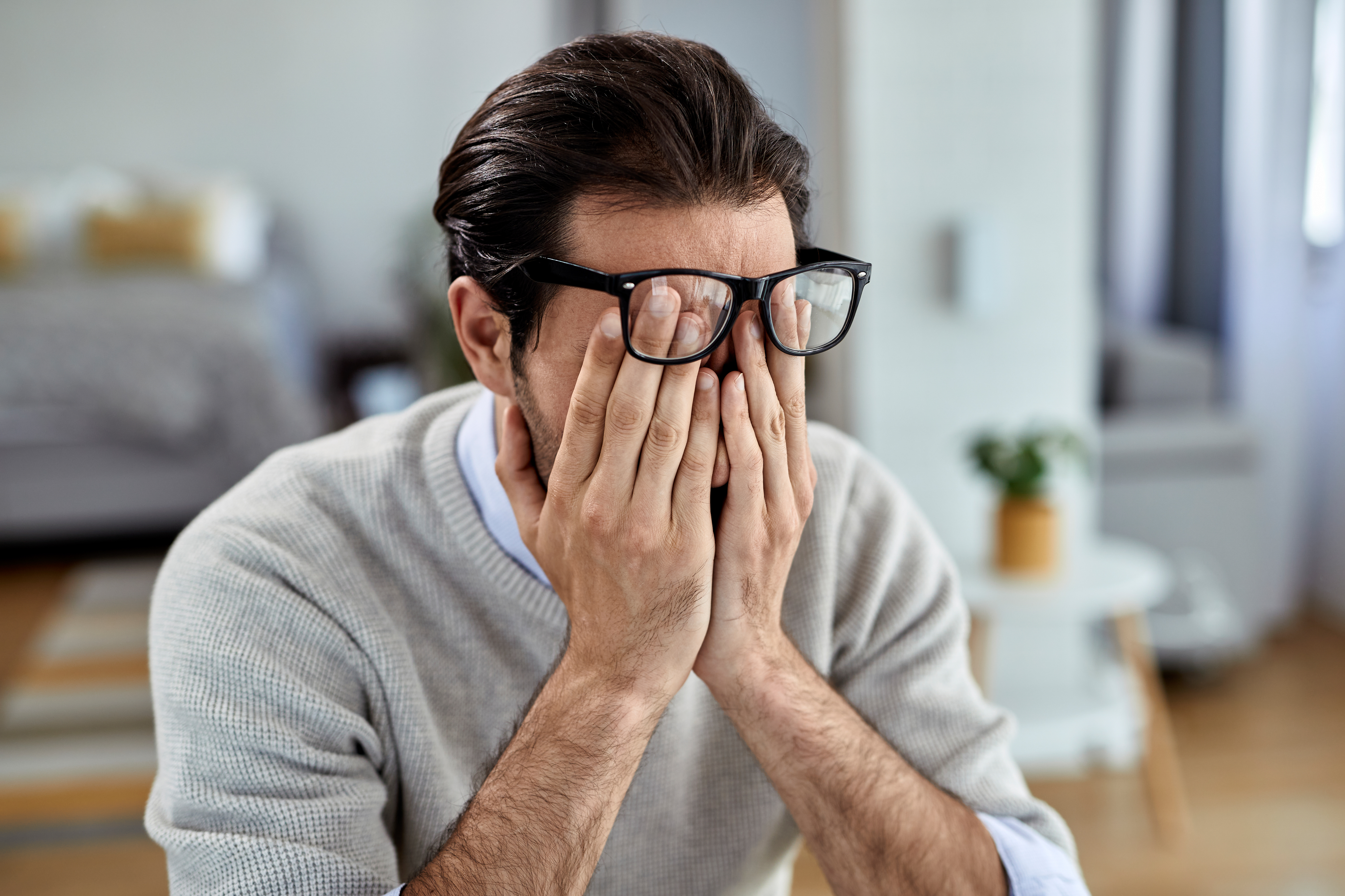 Business owner looking concerned while reviewing their website on a laptop
