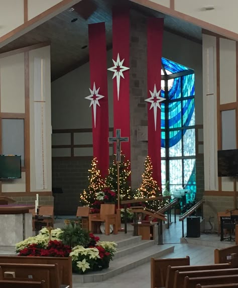 Dazzling church front holiday display adorned with wreaths, lights, and nativity figures, welcoming joyous Christmas worshippers.