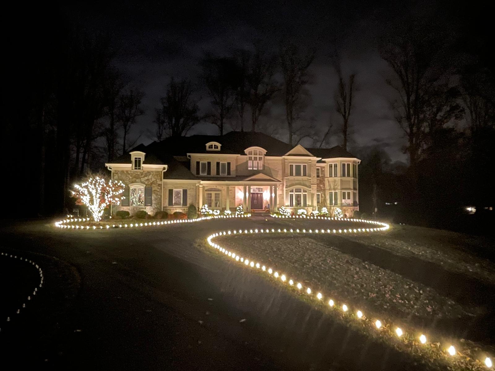 Warm string lighting installed along a home's roofline for a festival celebration